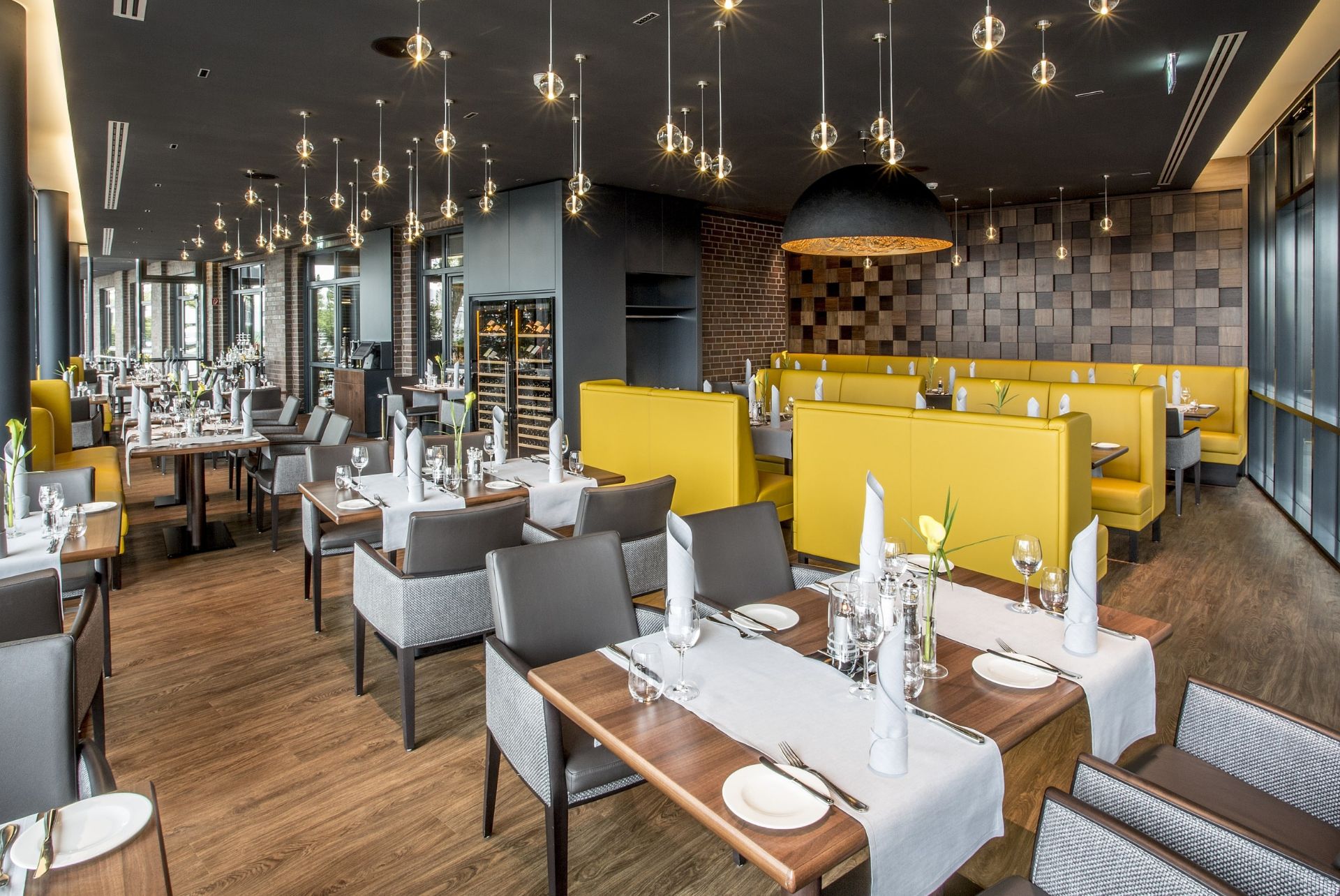 Modern hotel restaurant with elegantly laid tables, stylish lighting and inviting design