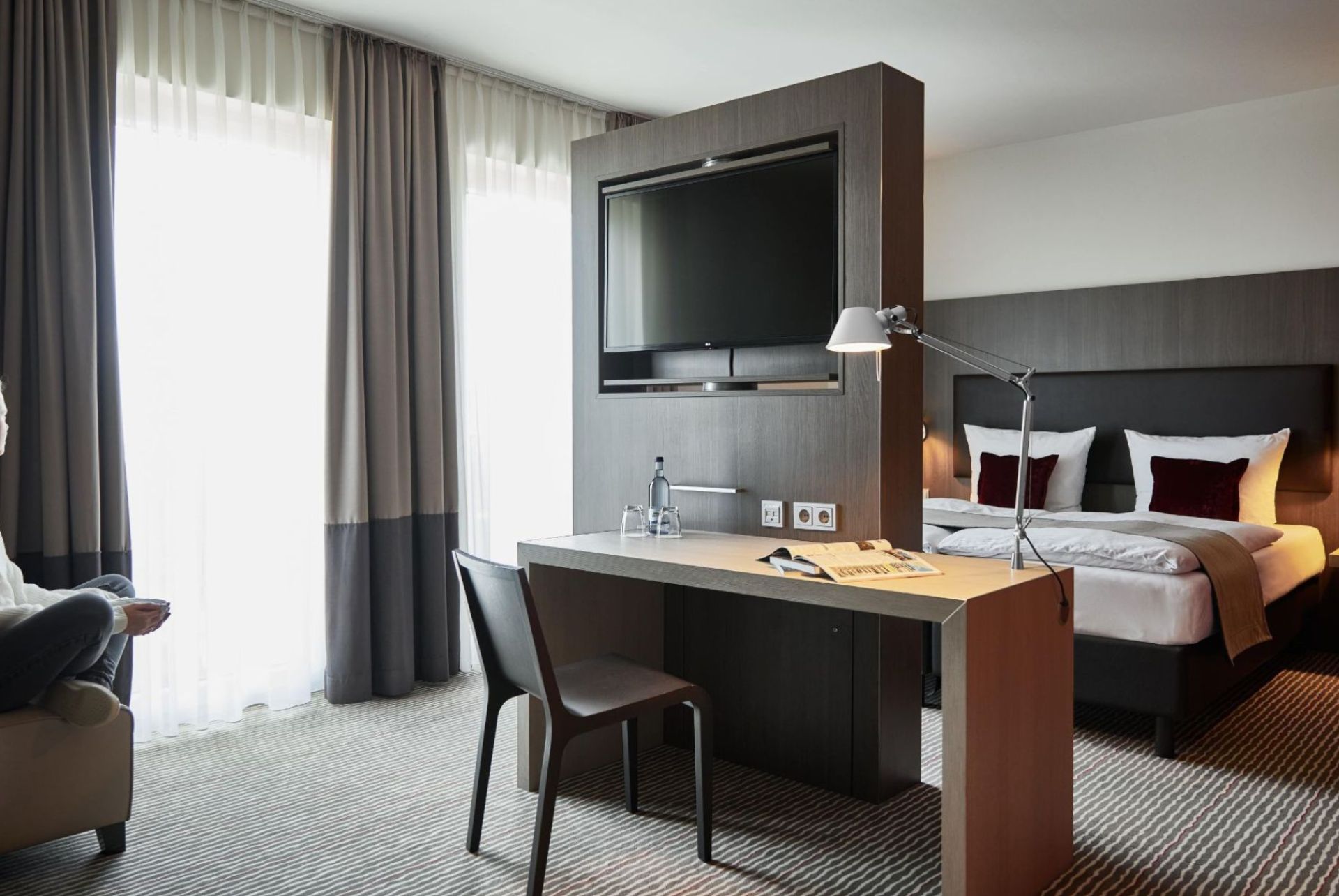 Modern and stylish hotel room with elegant design, comfortable double bed and functional work area