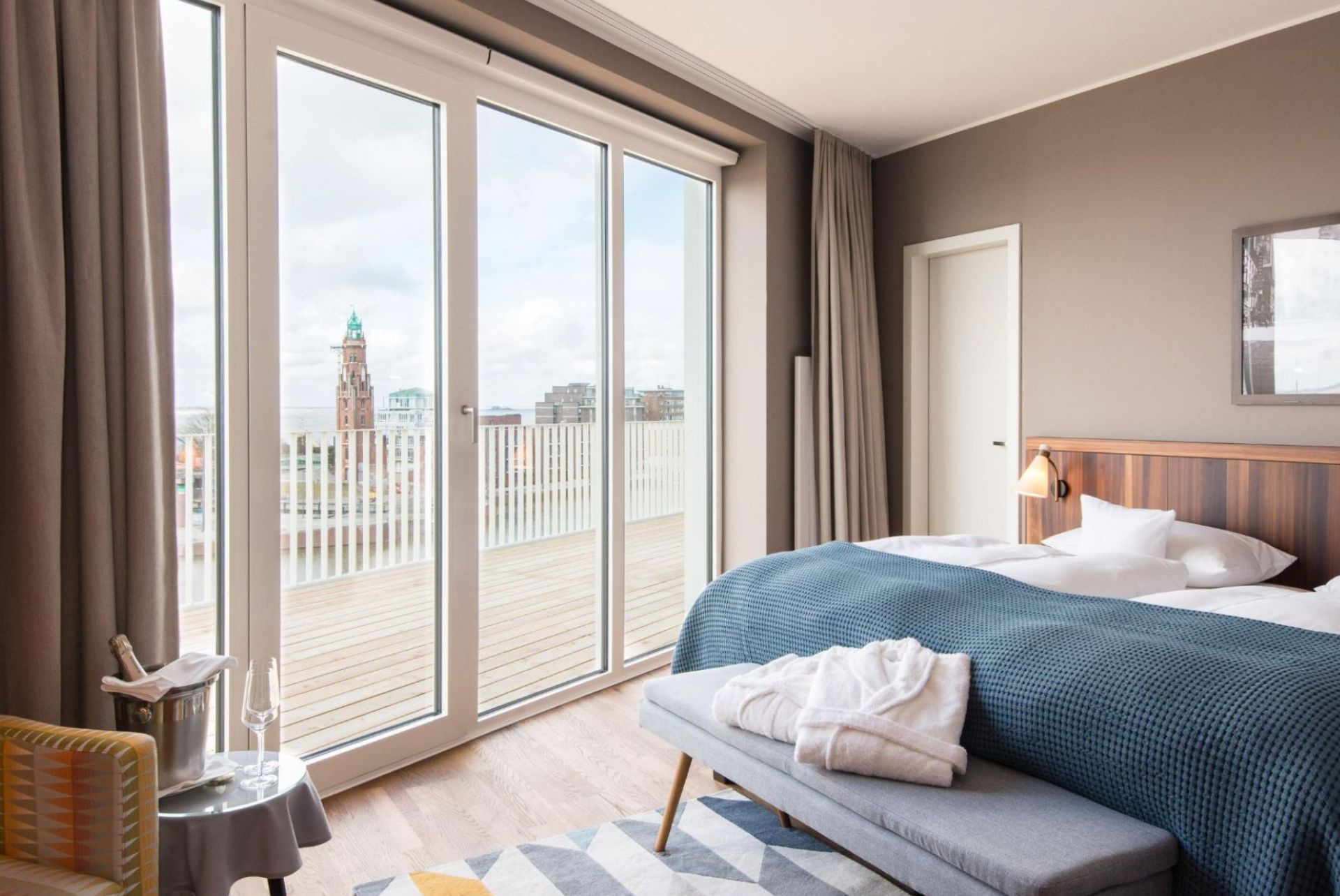 Bright and stylish BW Signature Collection hotel room with a modern design, comfortable double bed and large window front with a view of the city.