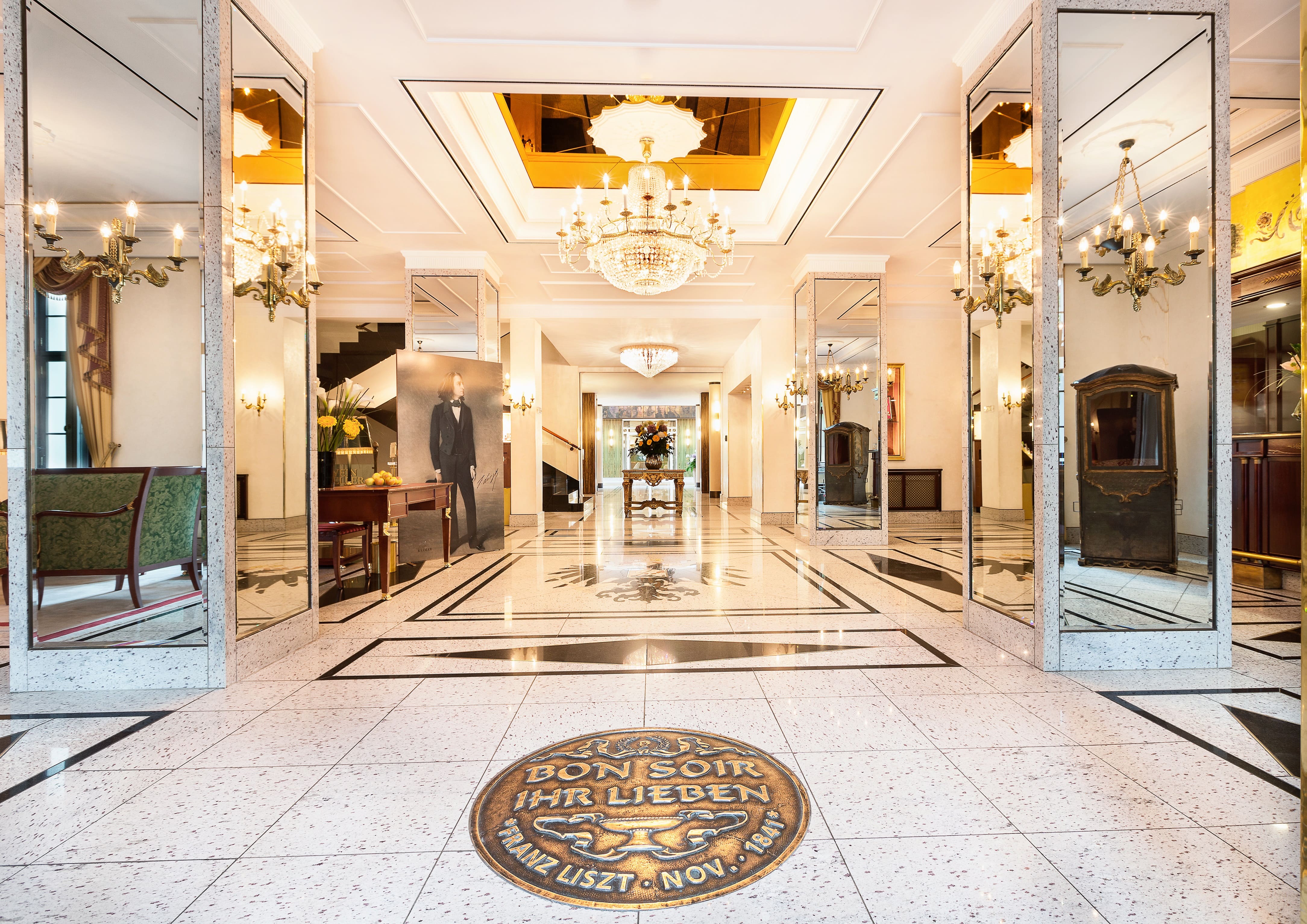 Magnificent hotel lobby with fine marble, gleaming mirrors and impressive chandeliers for a luxurious ambience